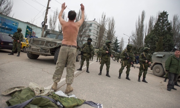A Ukranian soldier tries to persuade Russian troops to move away from a Ukrainian military base in Balaklava, Crimea on Saturday. Photograph: Anton Pedko/EPA